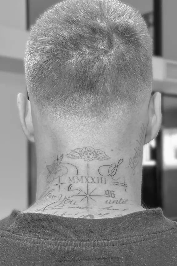 Neck tattoo with Roman numerals and stars by Chelsea.Q at Omnia Tattoo Studio